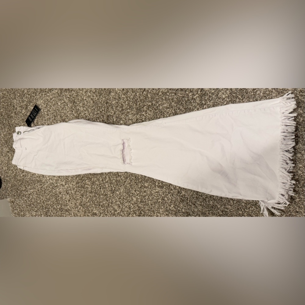 Jeans. Distressed on both knees with frayed hem. White. Size large.